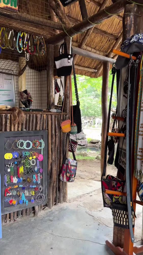 A curio stand selling beaded jewellery, woven bags and traditional cloth